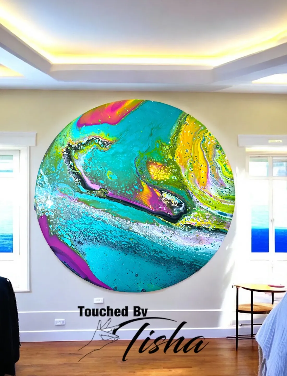A large round painting of a blue and green abstract.