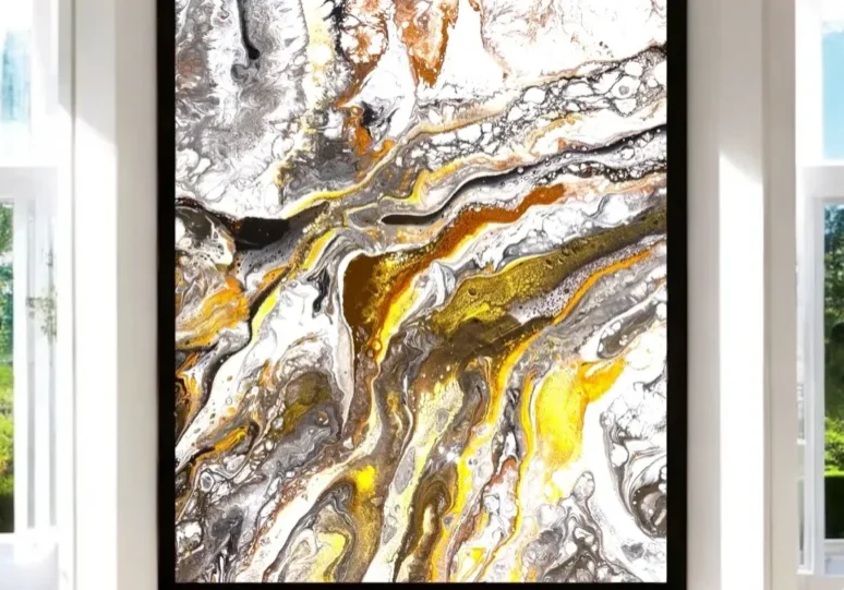 A painting of yellow and white swirling paint.